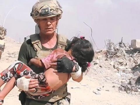 Soldier holding child