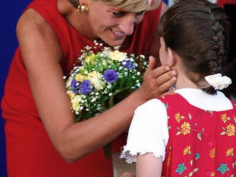 Princess Diana with flowers and child